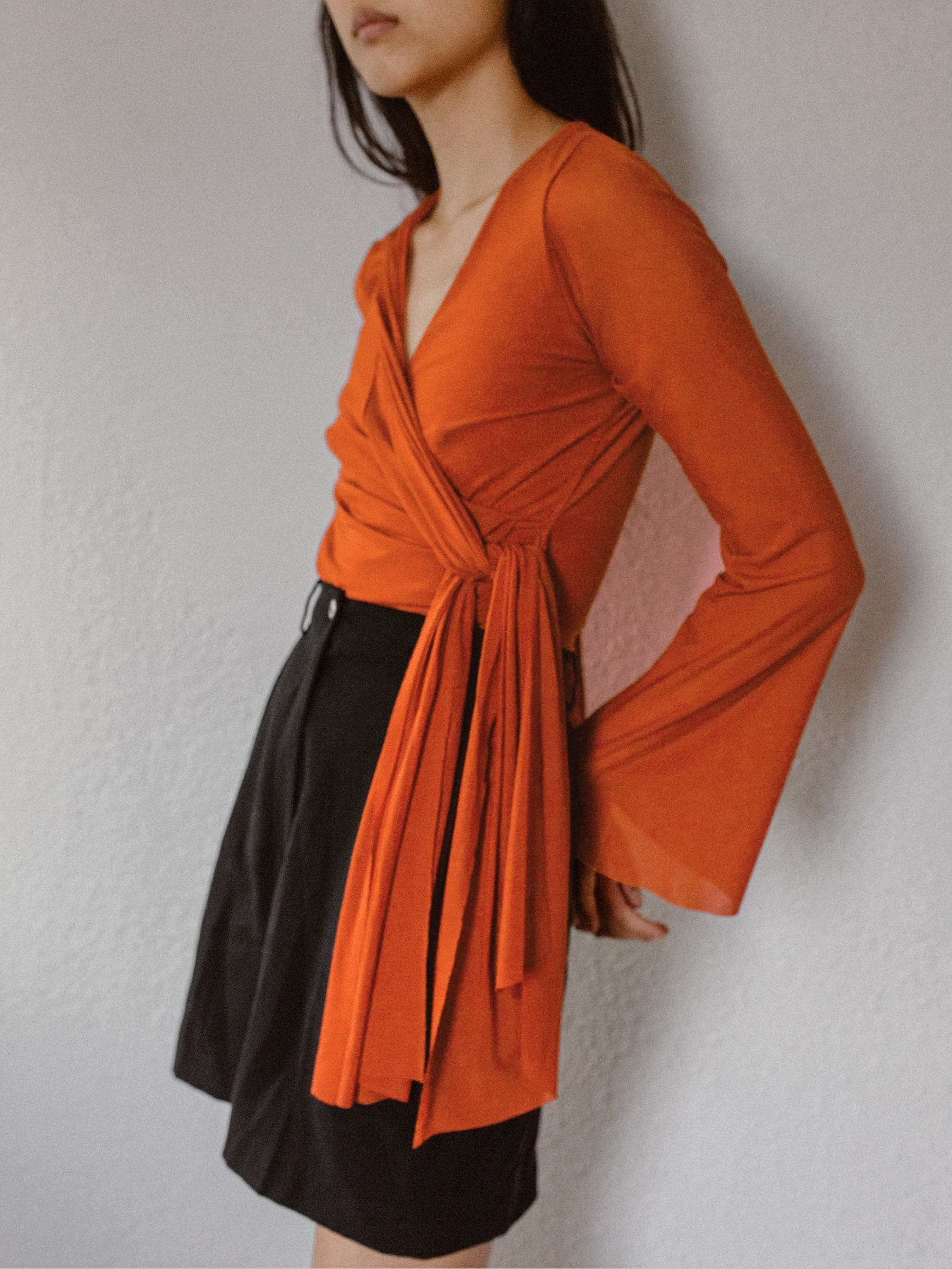 Bright orange mesh wrap top