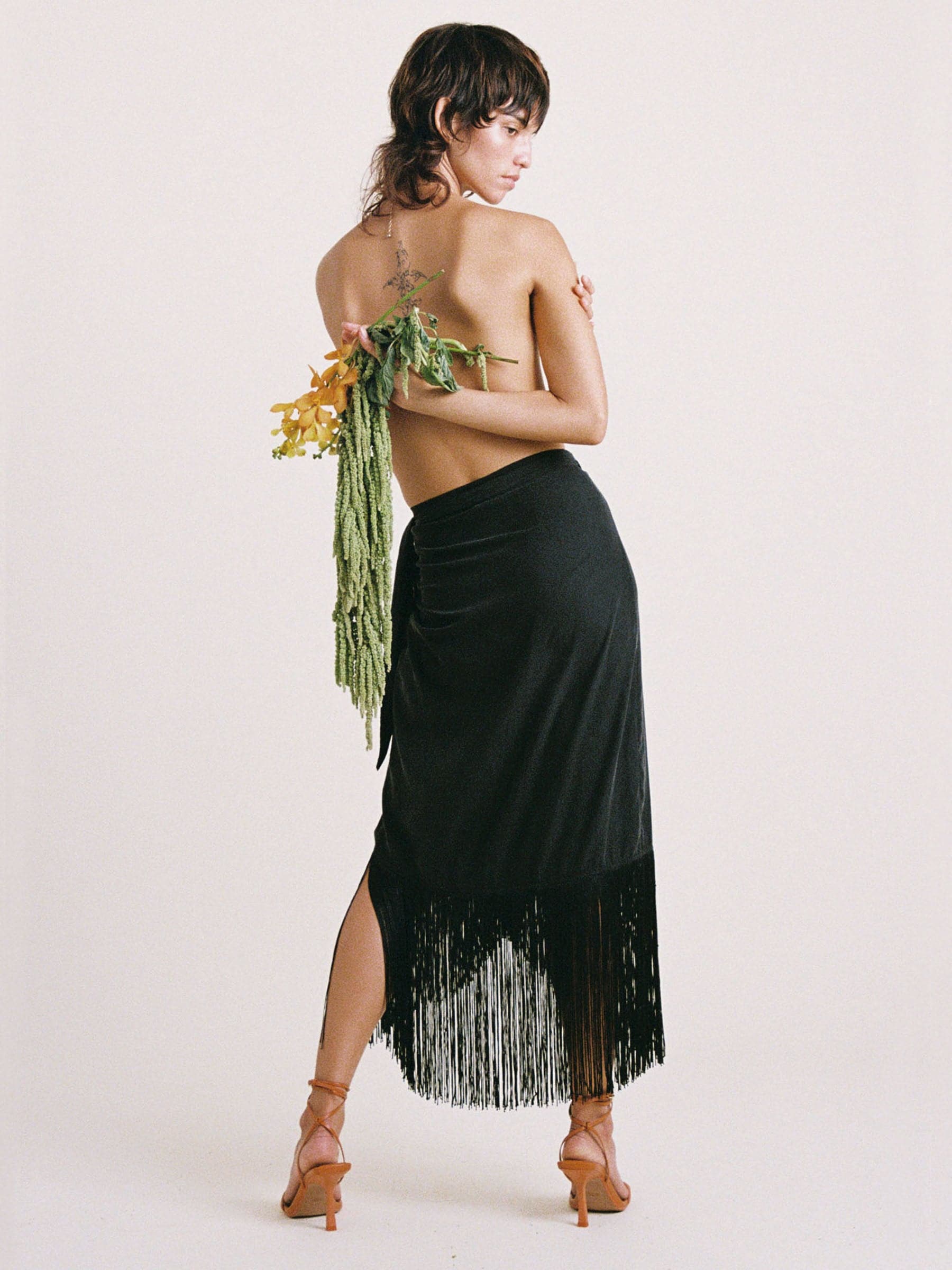 Black sustainable Tencel wrap skirt with fringe